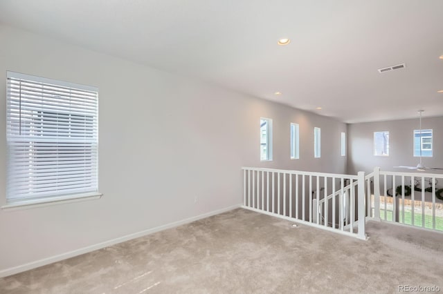 empty room featuring baseboards, carpet flooring, recessed lighting, and visible vents