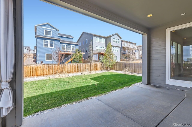 view of yard with a residential view, a patio, and a fenced backyard