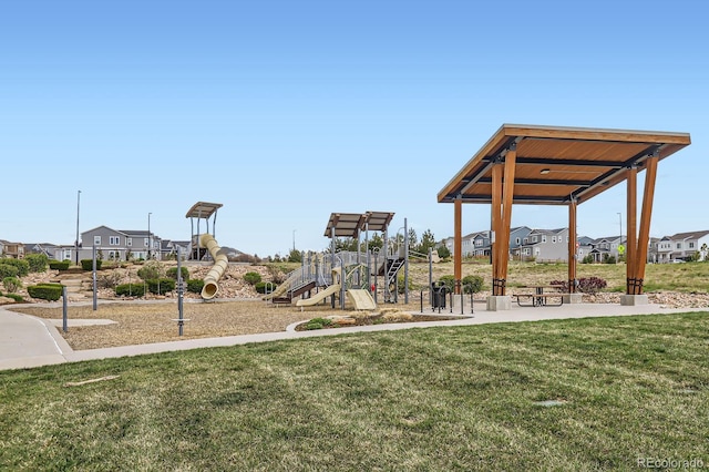 community play area featuring a lawn and a residential view