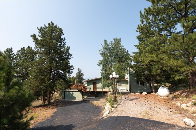 view of front of home featuring a garage and a deck