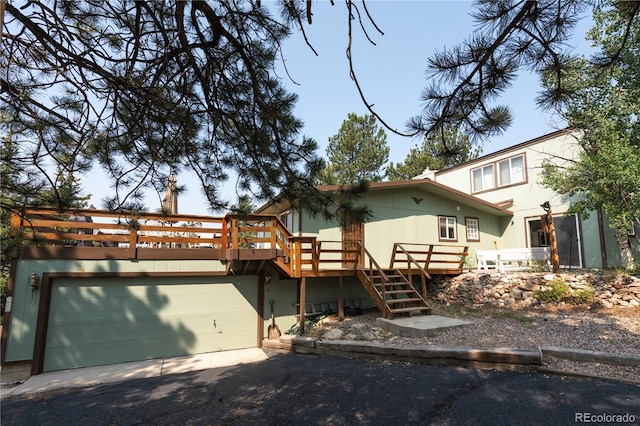 view of front facade with a garage and a deck