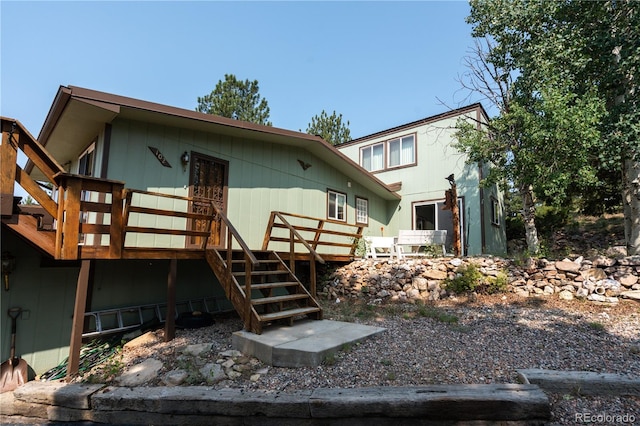 rear view of property featuring a wooden deck