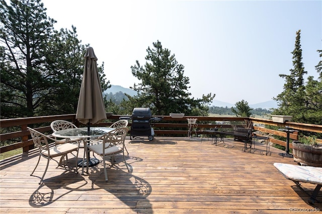 wooden terrace featuring area for grilling and a mountain view