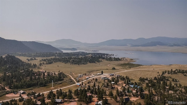 bird's eye view with a water and mountain view