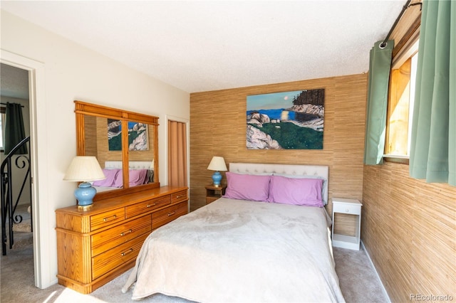 carpeted bedroom with wooden walls