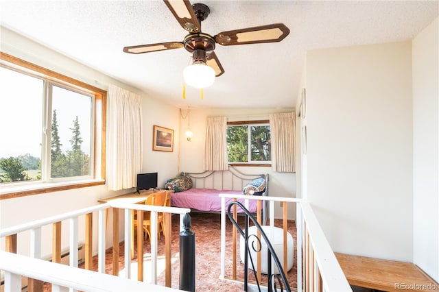 bedroom featuring ceiling fan and a textured ceiling