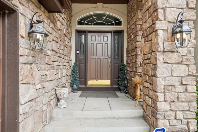 entrance to property with stone siding