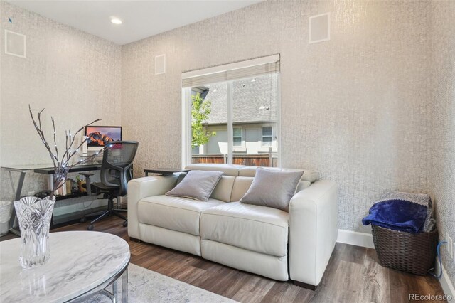 living area with baseboards and wood finished floors