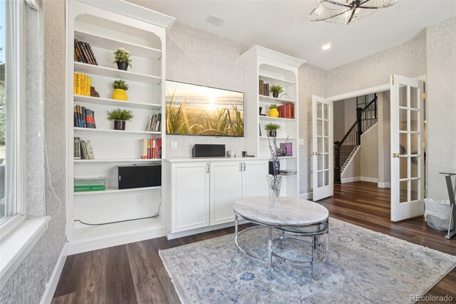 living area featuring french doors and dark wood-style floors