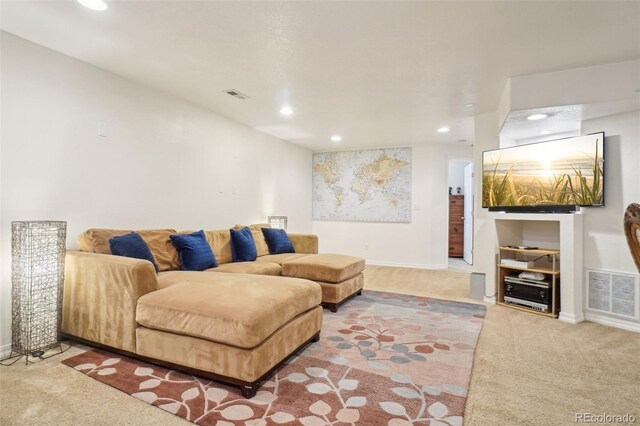 carpeted living room with visible vents, recessed lighting, and baseboards