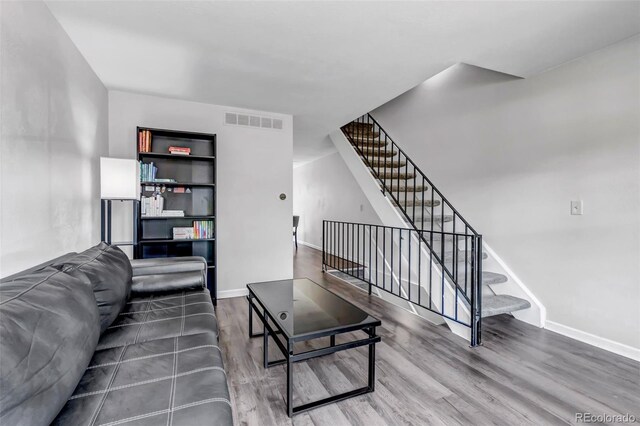 8905 Field St Unit 91, Westminster, CO 80021 - living room featuring wood finished floors, baseboards, and stairs