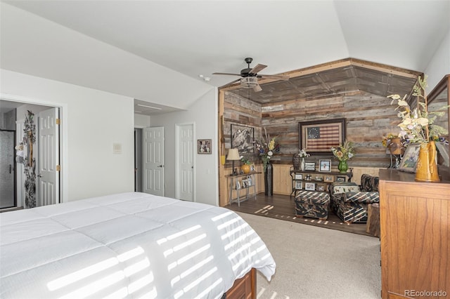 bedroom featuring lofted ceiling, wood walls, and dark hardwood / wood-style flooring