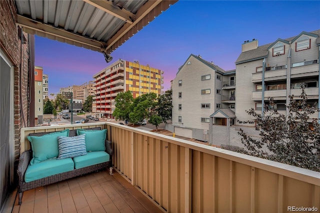 balcony at dusk with a view of city