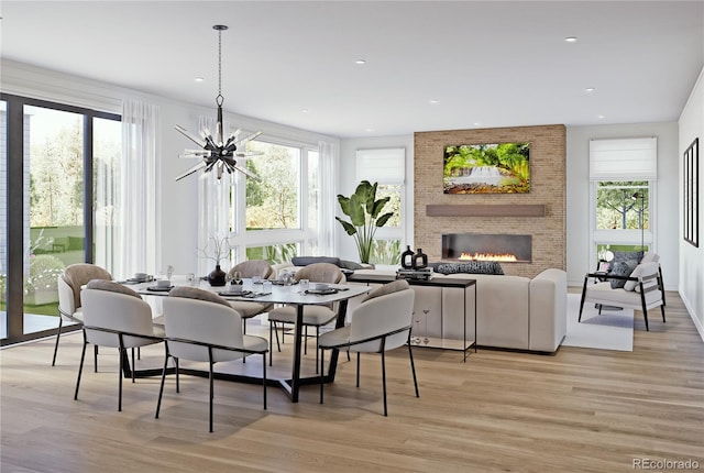 2778 Utica St, Denver, CO 80212 - dining space with a fireplace, light wood-type flooring, healthy amount of natural light, a chandelier, and recessed lighting