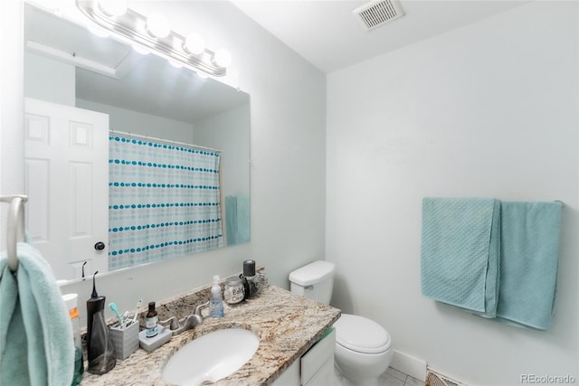 bathroom with vanity, toilet, and walk in shower