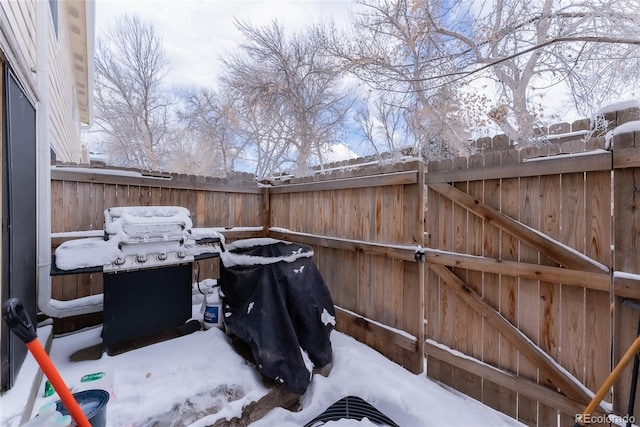 snow covered patio featuring grilling area