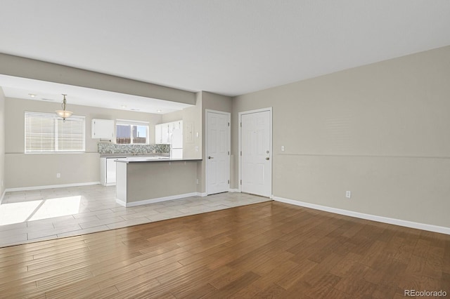 unfurnished living room featuring light hardwood / wood-style floors