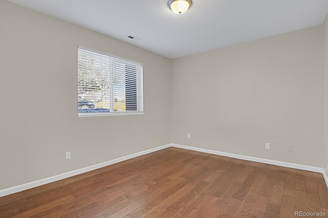 empty room featuring wood-type flooring