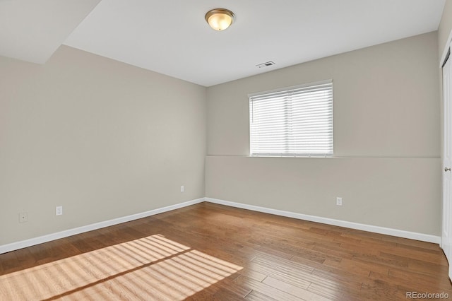 unfurnished room with hardwood / wood-style floors