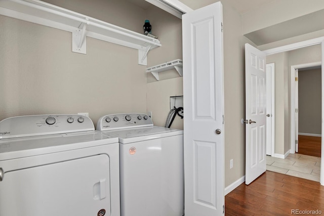 laundry area with washer and clothes dryer and dark hardwood / wood-style floors