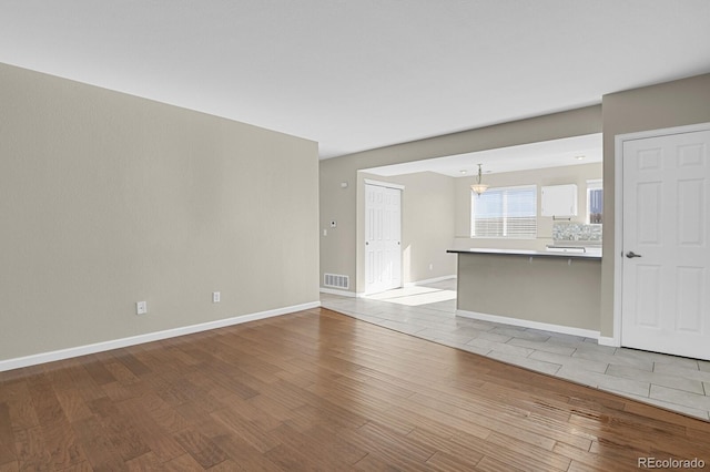 unfurnished living room with light wood-type flooring