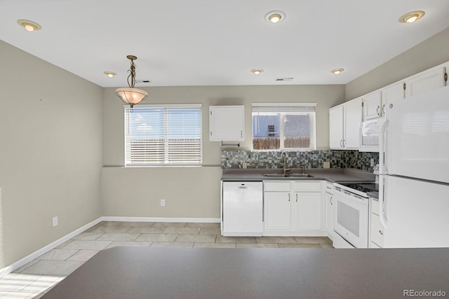 kitchen with tasteful backsplash, decorative light fixtures, sink, white appliances, and white cabinetry