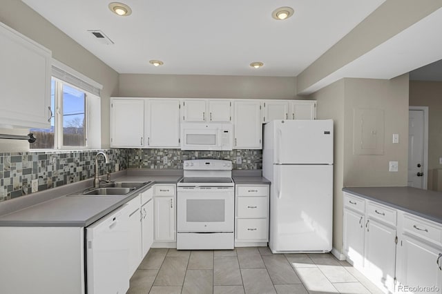 kitchen featuring light tile patterned floors, white cabinetry, tasteful backsplash, white appliances, and sink