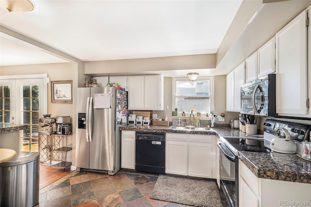 7780 S Kendall Blvd, Littleton, CO 80128 - kitchen featuring black appliances, white cabinetry, stone tile flooring, and tile counters