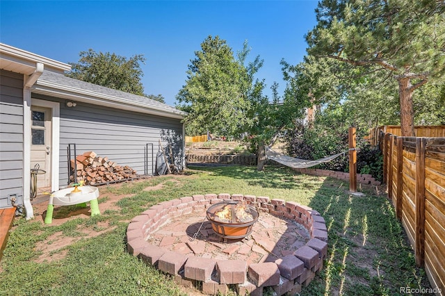 7780 S Kendall Blvd, Littleton, CO 80128 - fenced backyard with a fire pit and a patio area