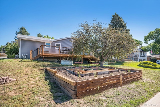 7780 S Kendall Blvd, Littleton, CO 80128 - back of house featuring a vegetable garden, a wooden deck, and a lawn