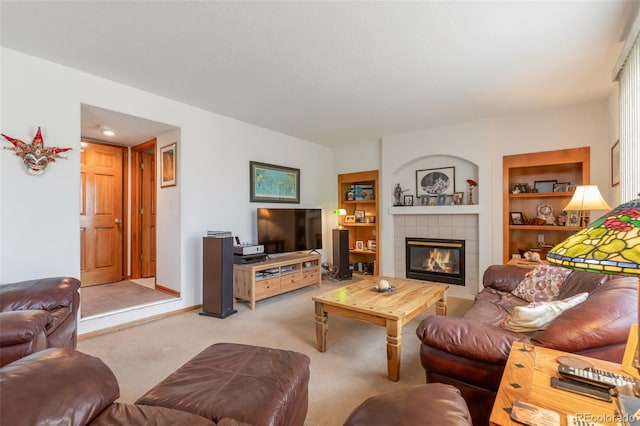 carpeted living room with built in shelves and a tiled fireplace