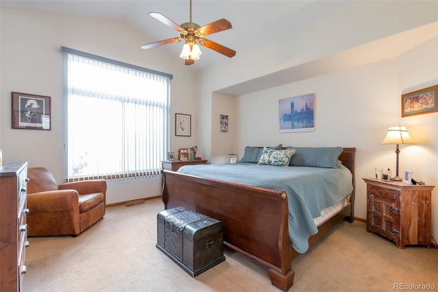 bedroom with ceiling fan, light colored carpet, and vaulted ceiling