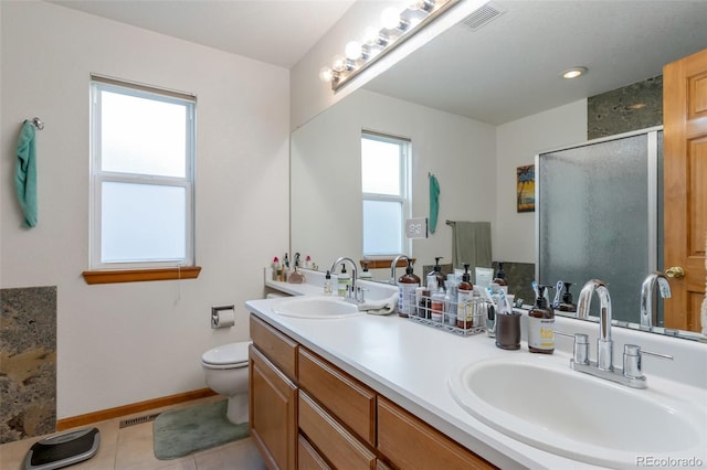 bathroom with toilet, a shower with door, vanity, and tile patterned flooring