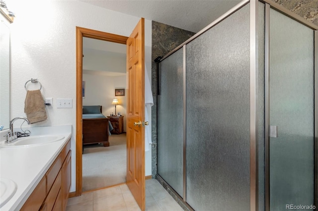 bathroom with vanity, tile patterned floors, and an enclosed shower