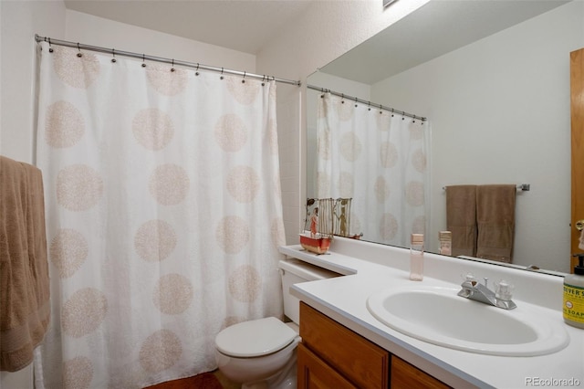 bathroom with toilet and vanity