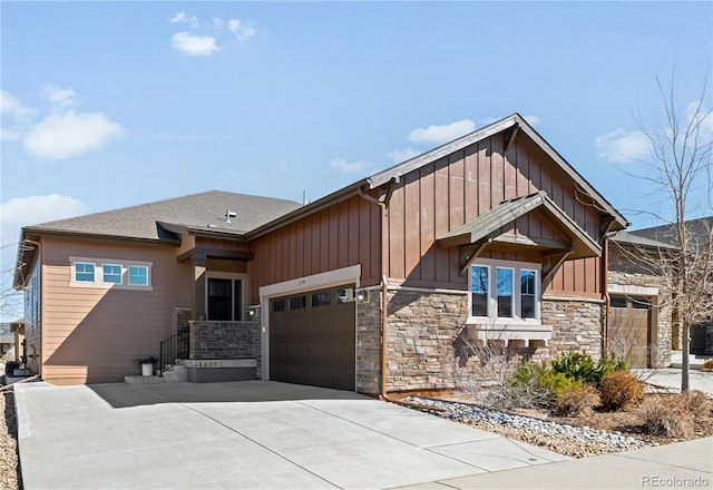 view of front of property with an attached garage, driveway, stone siding, roof with shingles, and board and batten siding