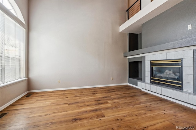 unfurnished living room featuring a fireplace and hardwood / wood-style floors