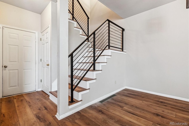 stairway with hardwood / wood-style flooring