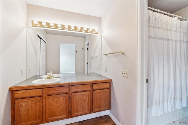 bathroom featuring vanity, hardwood / wood-style flooring, and walk in shower