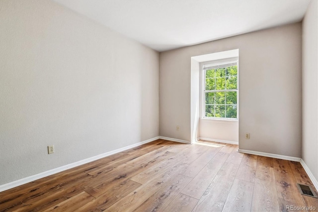 spare room featuring light hardwood / wood-style flooring