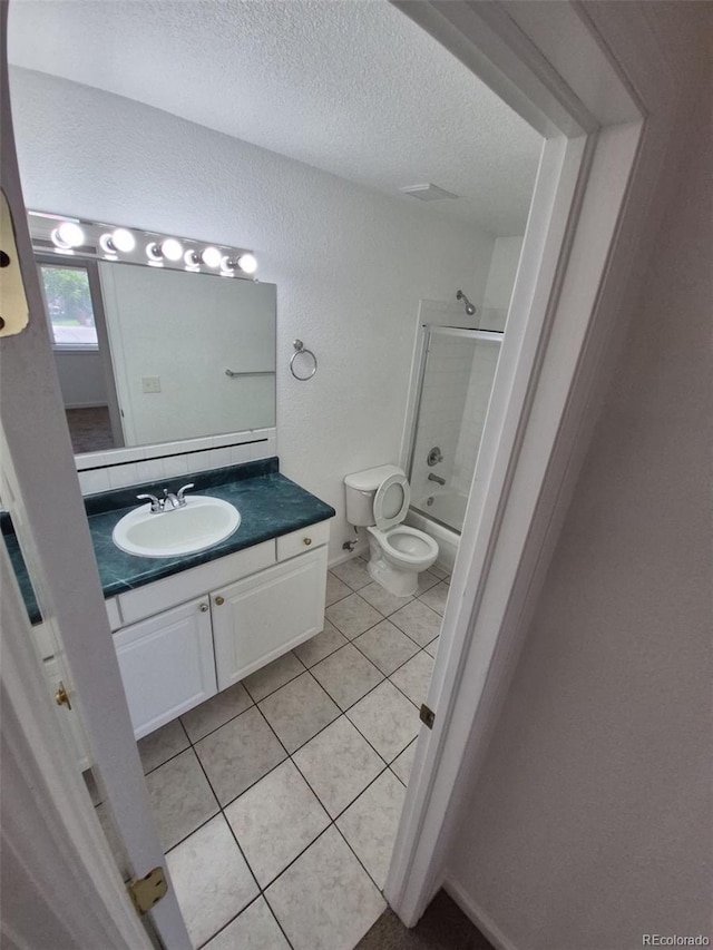 894 S Krameria St, Denver, CO 80224 - bathroom with tile patterned flooring, vanity, tub / shower combination, a textured ceiling, and toilet