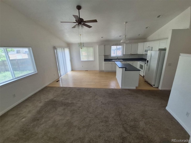 894 S Krameria St, Denver, CO 80224 - kitchen featuring light carpet, vaulted ceiling, white appliances, white cabinetry, and a sink