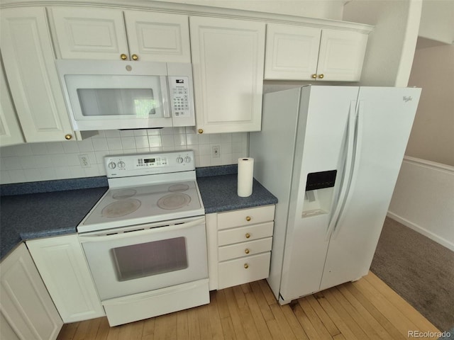 894 S Krameria St, Denver, CO 80224 - kitchen with white appliances, dark countertops, decorative backsplash, and white cabinets