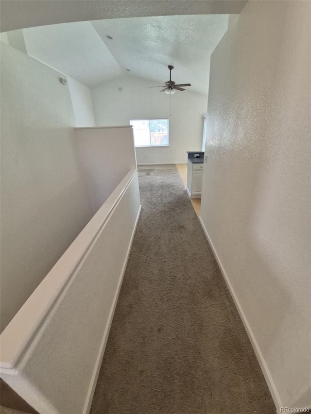 894 S Krameria St, Denver, CO 80224 - hallway with an upstairs landing, vaulted ceiling, light colored carpet, and baseboards