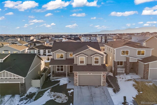 snowy aerial view with a residential view