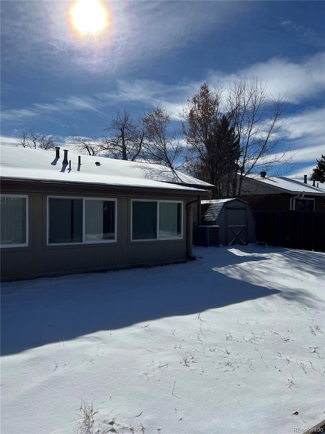 exterior space featuring a shed and central AC unit