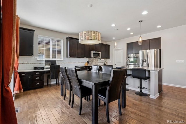 dining area with light wood-style floors, visible vents, baseboards, and recessed lighting