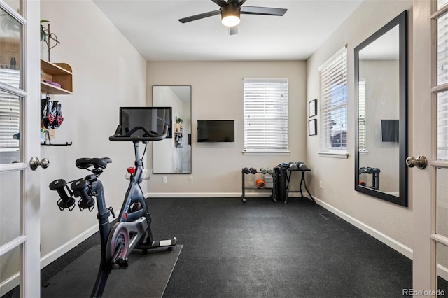 exercise area featuring a ceiling fan and baseboards