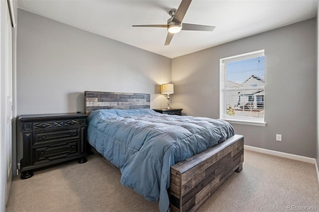 bedroom featuring a ceiling fan, light carpet, and baseboards