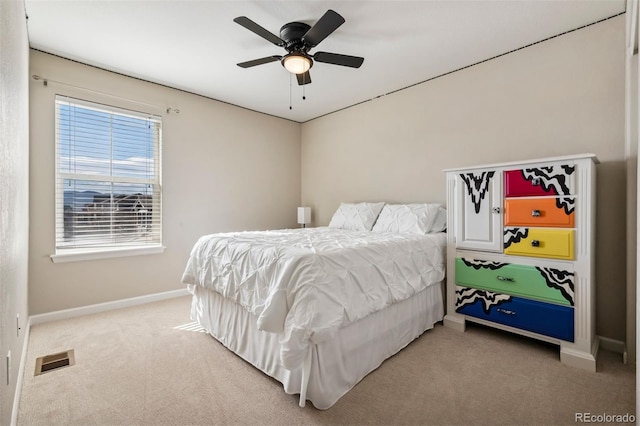 bedroom featuring baseboards, visible vents, a ceiling fan, and light colored carpet